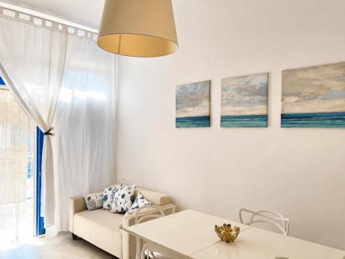 a living room with a couch and a table at Pietra & Mare Ostuni in Villanova di Ostuni