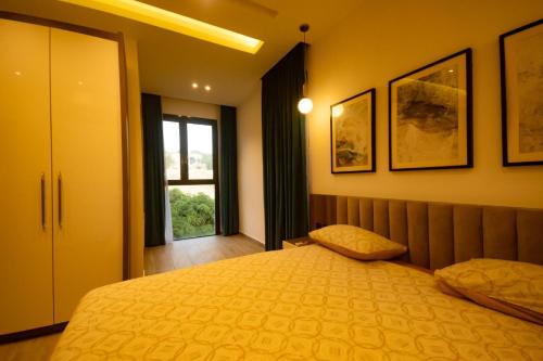 a bedroom with a large bed and a window at Elegant Hillside Ocean Stay in Freetown
