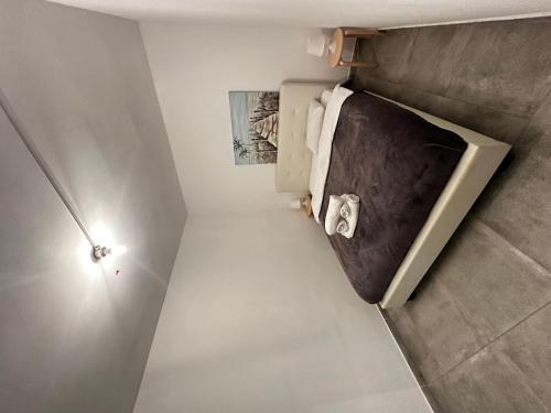 a small bathroom with a refrigerator in a room at Arsenia Cottage D - Kyperounta in Kyperounda