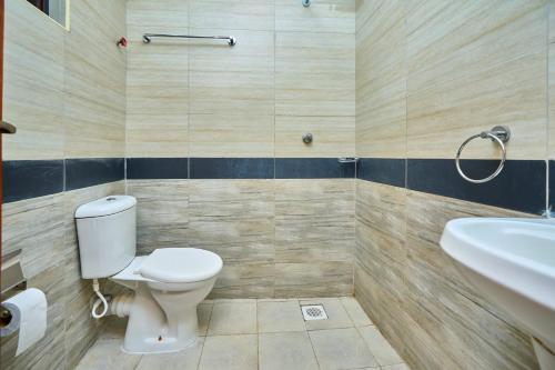 a bathroom with a toilet and a sink at 4 Bedroom Apartment Near JKIA & SGR in Nairobi