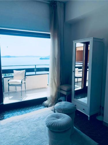 a room with a mirror and a chair on a balcony at Suite bijoux On Lake Maggiore in Verbania