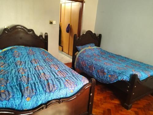 two beds sitting next to each other in a room at Mutabari's Home in Kitengela 