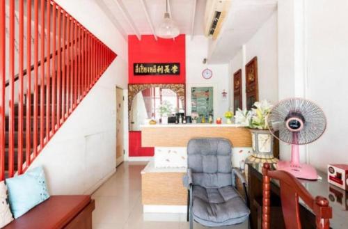 a room with a staircase with a red wall at 1137 Hostel in Bangkok