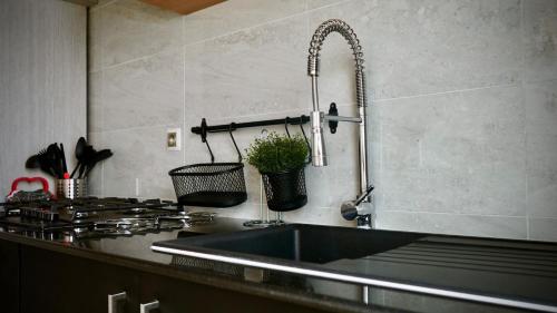 a kitchen counter with a sink and a stove at Villa La Gospa in Libreville