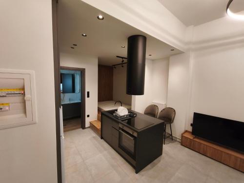 a living room with a desk and a television at Orestiada Centro apartment in Orestiada