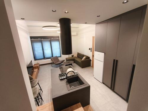 a kitchen and a living room with a couch at Orestiada Centro apartment in Orestiada