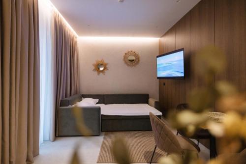 a hotel room with a bed and a flat screen tv at Hotel Digreis in Vlorë