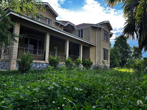 a house with a lot of weeds in front of it at House in Katex