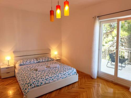 a bedroom with a bed and a large window at Apartment Mila in Primošten