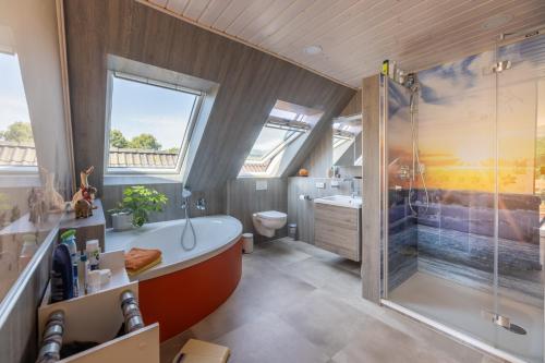 a bathroom with a large tub and a shower at Appartement auf dem Land in Neuenkirchen