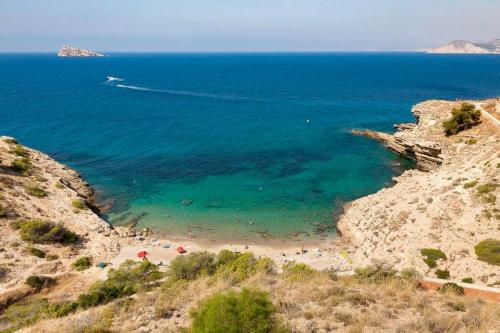 an aerial view of a beach with people in the water at Kampaoh Playa de Levante in Benidorm
