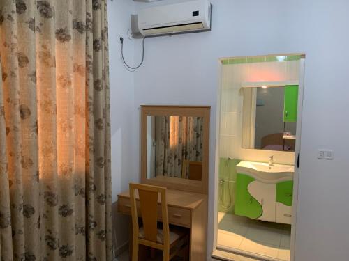 a bathroom with a sink and a mirror at Montazah Residence in Dar el Koudia