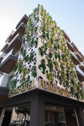 a building with plants on the side of it at Hera Hotel in Alexandroupoli