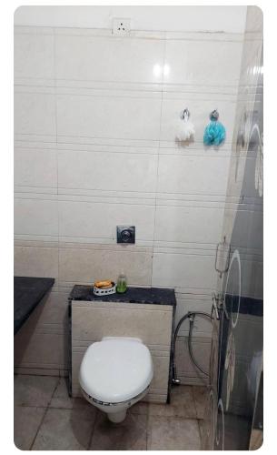 a bathroom with a white toilet in a room at 3BHk flat family friendly in Raipur