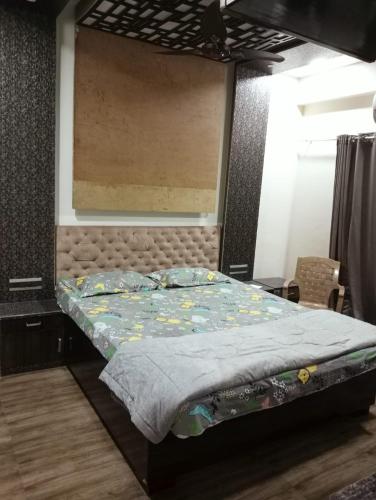 a bedroom with a large bed with a headboard at 3BHk flat family friendly in Raipur