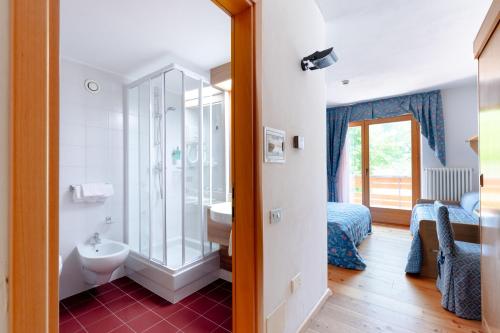 a bathroom with a shower and a toilet and a sink at Garni Lago Nembia in San Lorenzo in Banale