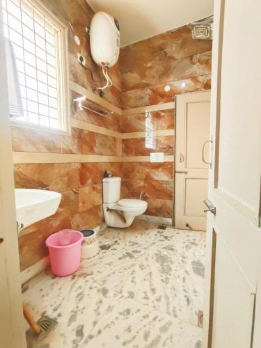 a bathroom with a toilet and a sink at Om Homestay in Panchkula