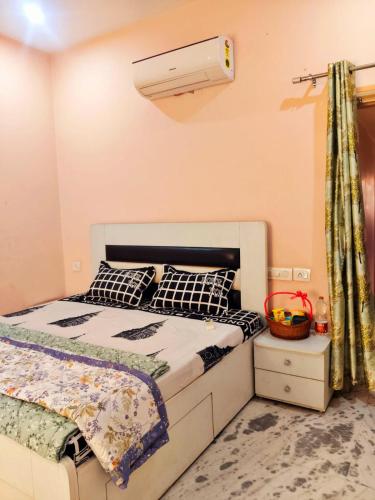 a bedroom with a bed and a air conditioner at Om Homestay in Panchkula