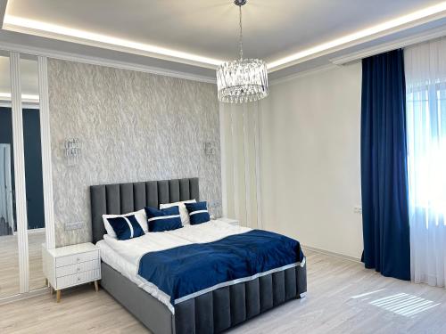 a bedroom with a large bed with blue pillows at Events house With Swimming Pool in Agarak