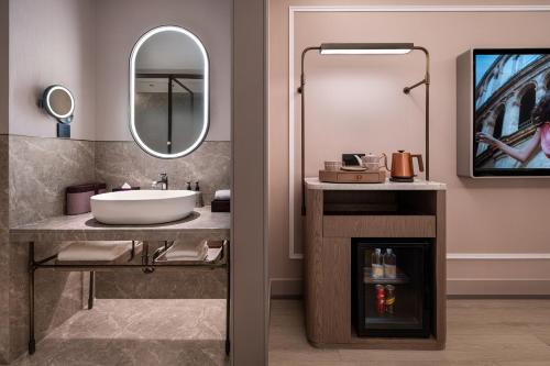 a bathroom with a sink and a mirror at Mercure Beijing Lize Road in Beijing