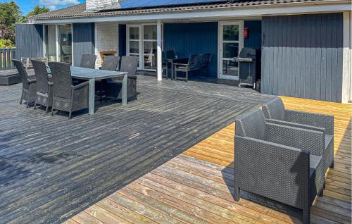 a wooden deck with a table and chairs on it at 3 Bedroom Nice Home In Hals in Hals