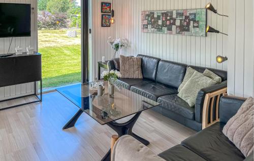 a living room with a couch and a glass table at 3 Bedroom Nice Home In Hals in Hals