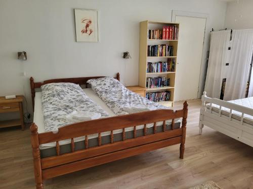 a bed in a room with a book shelf at Old village school in Kolkontaipale