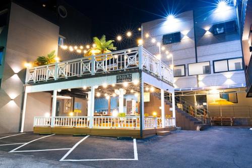 a building with a balcony on the side of it at Donghae Gloria Pension in Donghae
