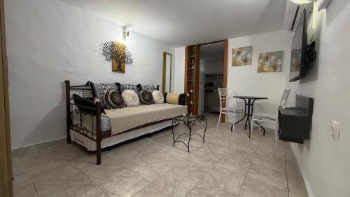 a living room with a couch and a table at Arena's nest in Áyioi Dhéka