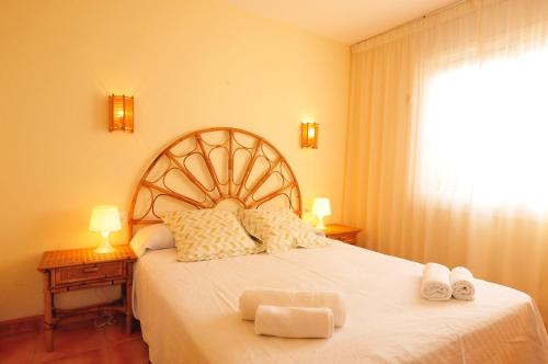 um quarto com uma cama grande com duas toalhas em HomeHolidaysRentals Aqua em Santa Susanna