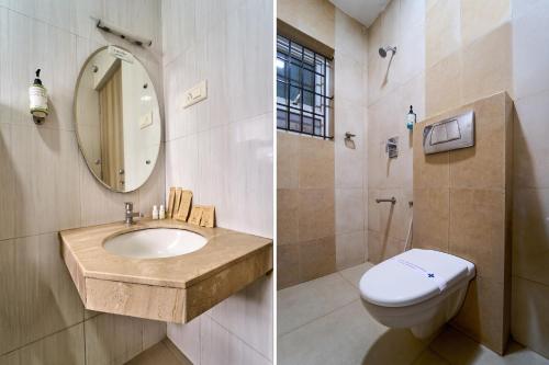 a bathroom with a sink and a toilet and a mirror at Treebo ESS Grande in Coimbatore