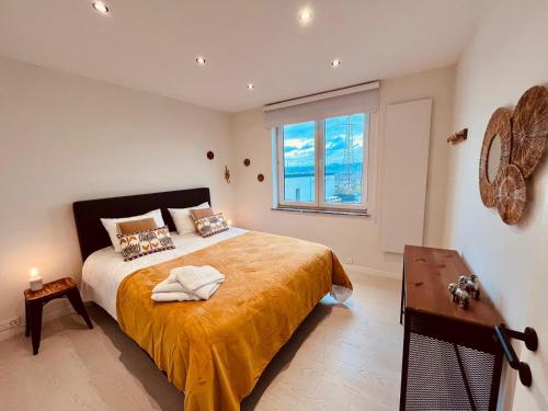 a bedroom with a large bed and a window at Cosy Of John Cockerill in Seraing