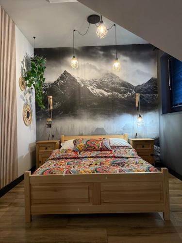 a bedroom with a bed with a painting on the wall at Agroturystyka Myślinów - Black Horse Bar&Grill in Męcinka