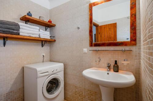 a bathroom with a washing machine and a sink at Metochi Villas in Spílion