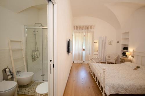 a bedroom with a bed and a tub and a sink at cottage lavanda e rosmarino in Lavis