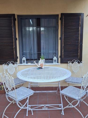 a table and chairs sitting on a patio at Angolo Azzurro in Asciano Pisano