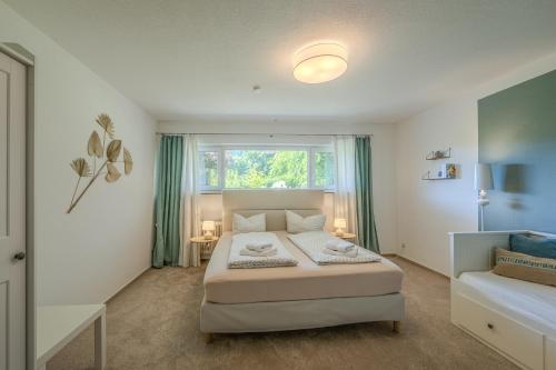 a bedroom with a large bed and a window at Fewo Strandliebe in Gaienhofen