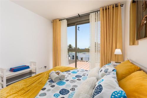 a bedroom with a bed and a large window at CarpeDiem Costa de Antigua in Costa de Antigua