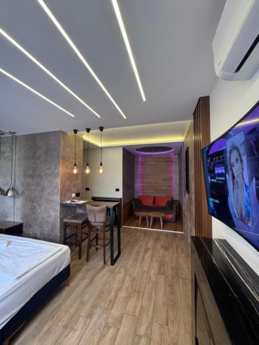a hotel room with a bed and a tv at Vila Romantika in Zlatibor