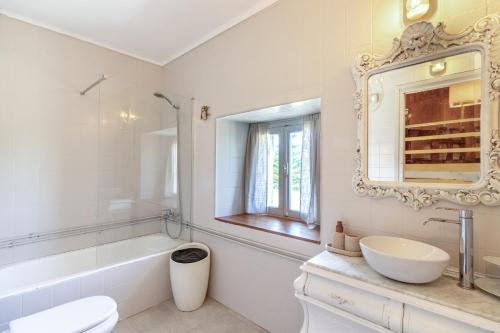a white bathroom with a sink and a mirror at Villa Vista Ajo in Ajo