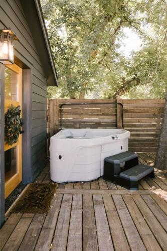 a white bath tub sitting on a wooden deck at Creekside Village Inn in Spearfish