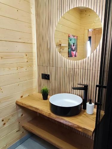 a bathroom with a round sink and a mirror at Mazurska Puszcza domek pod klonem z balią ogrodową in Budy