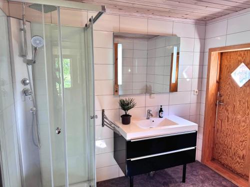 a bathroom with a sink and a shower at Stuga Gösjön in Berga