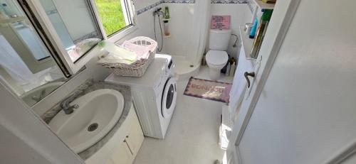 a small bathroom with a sink and a toilet at Casita Costa in Miengo