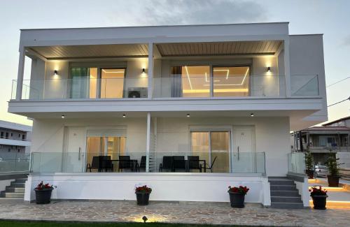 a large white house with a balcony at Kassiani Studios in Keramoti
