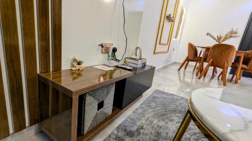 a living room with a desk and a fireplace at Little Afrika in Port Harcourt