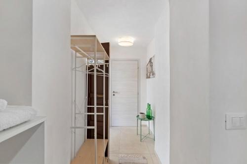 a white hallway with a glass door leading to a bedroom at Il Cortiletto 21 in Marsala