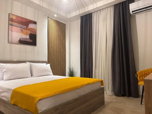 a bedroom with a bed with a yellow blanket at Ancient Philippi Luxury Apt MKP in Krinídhes