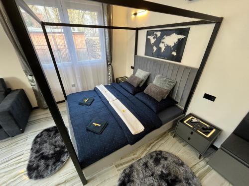 a bedroom with a bed with blue sheets and pillows at Csiszta Thermal Villa in Buzsák