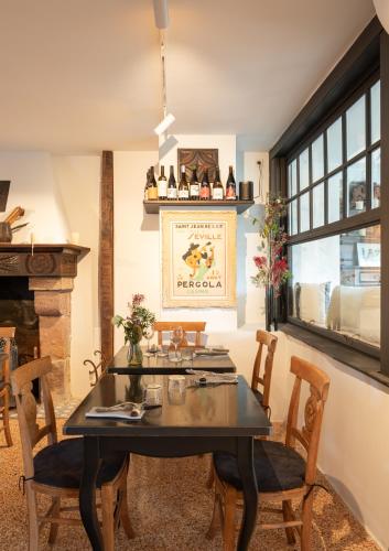 a dining room with a table and chairs and a fireplace at Auberge hiribarren in Biriatou